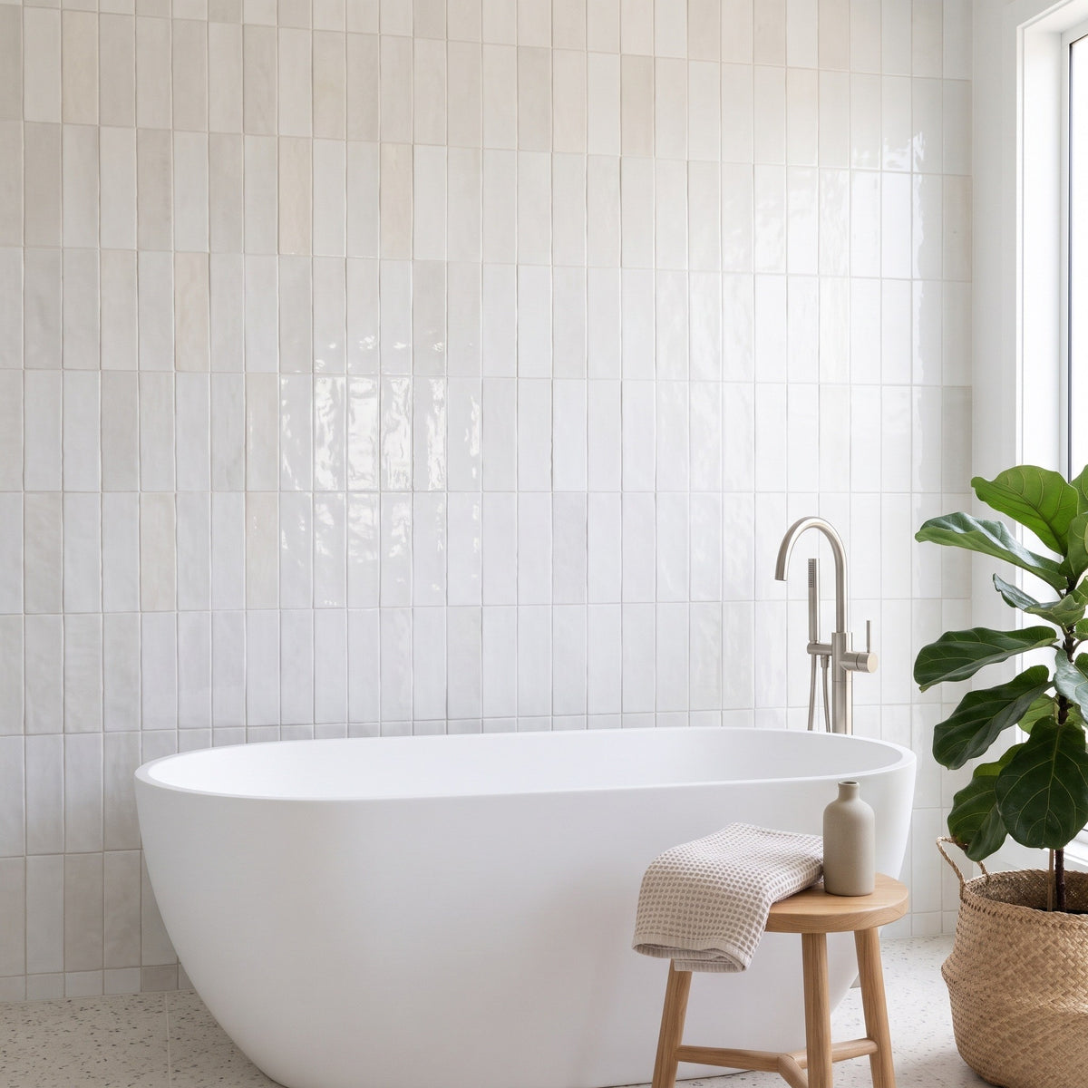 Marais White wall tiles – Freestanding bath, terrazzo floor
