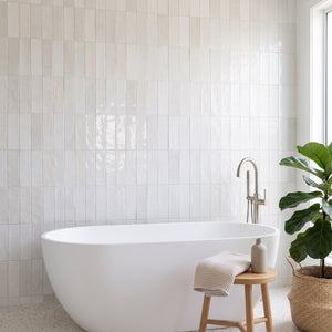 Marais White wall tiles – Freestanding bath, terrazzo floor
