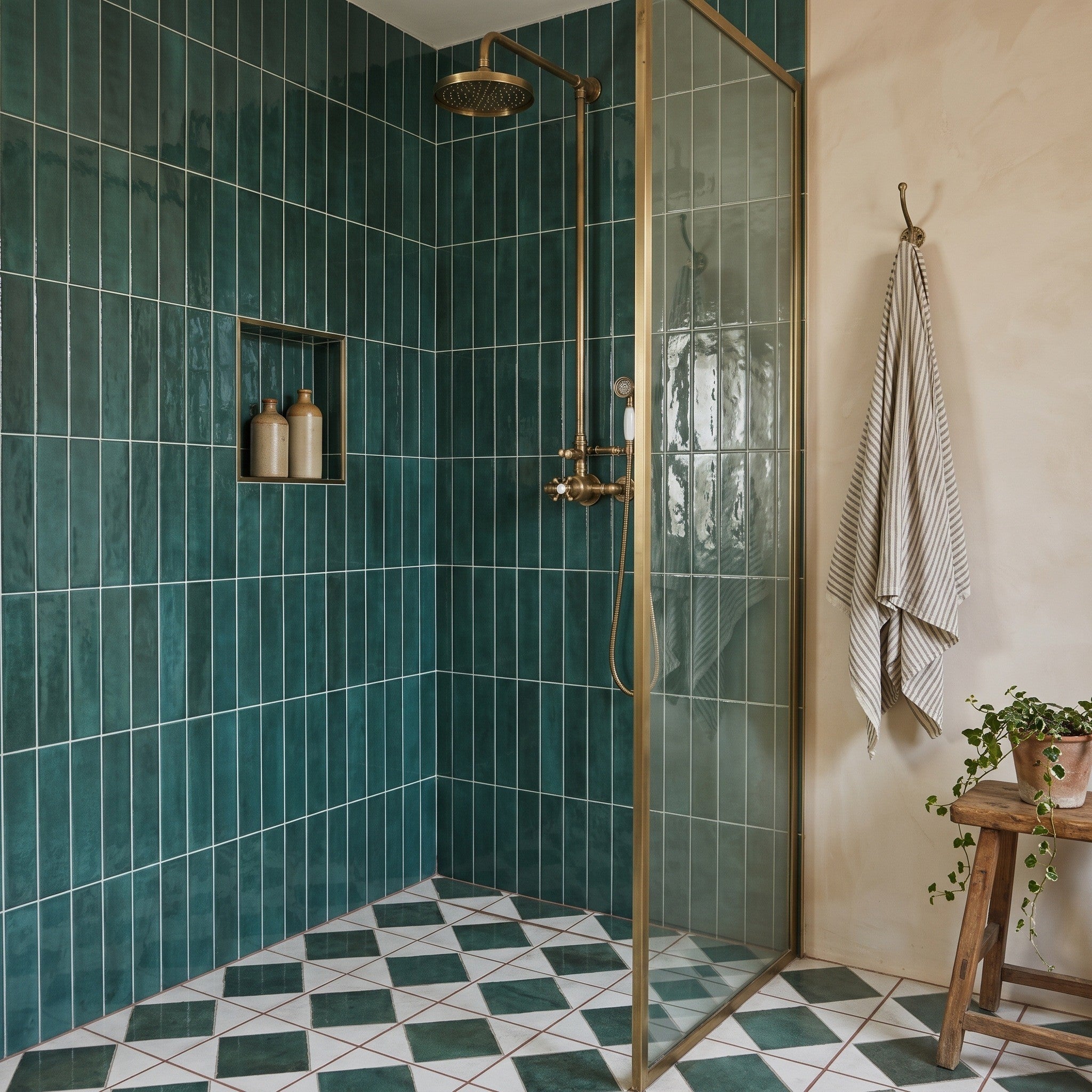 Opal Emerald wall tiles lining a walk-in shower with brass-framed glass screen, green-and-white diamond floor tiles below