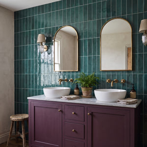 Opal Emerald wall tiles – Plum double vanity, arched brass mirrors